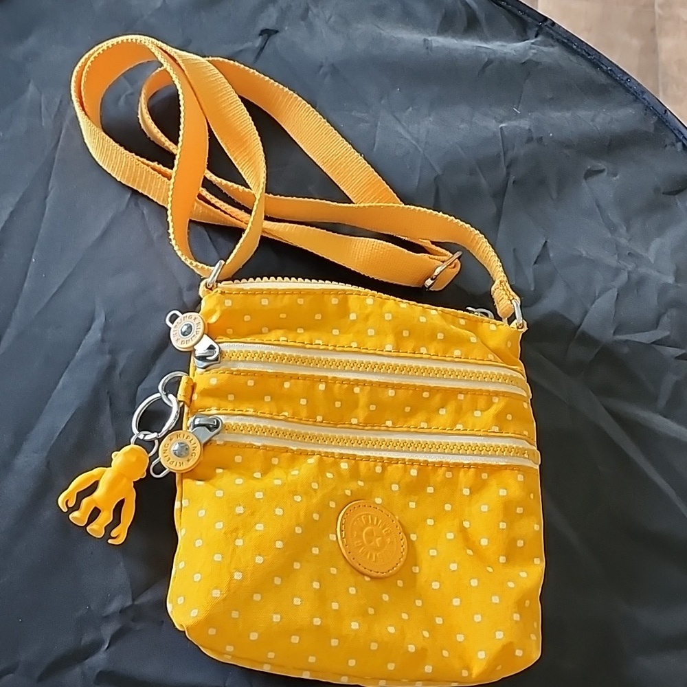 Well loved Kipling yellow mini crossbody purse with gorilla charm